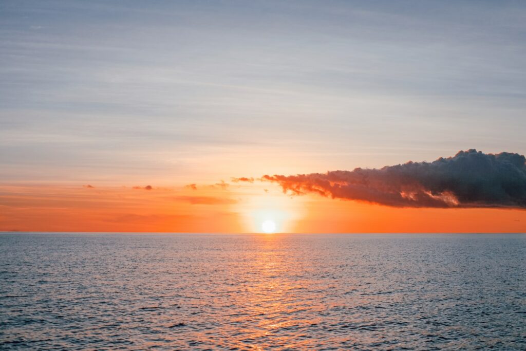 body of water during sunset