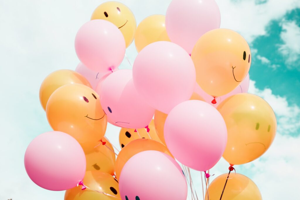 low-angle photo of pink and orange balloons célibat heureux