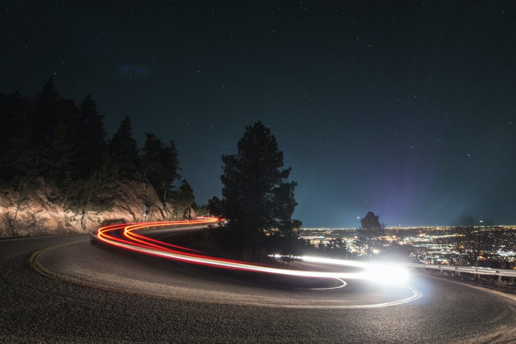 timelapse photography on curved road beside je tree je suis trop impulsive