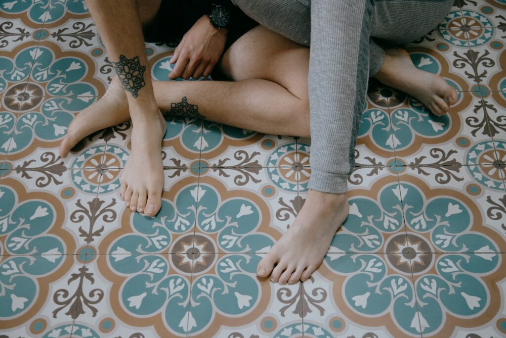 woman in gray leggings sitting on brown and white floral textile dating offline